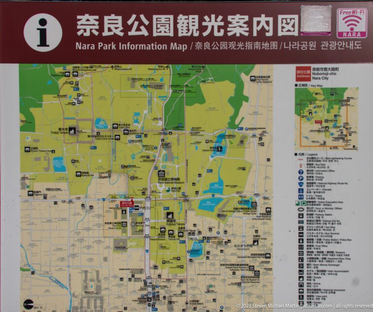 Multilingual Nara Park visitor map with paths, landmarks, ponds, symbols, and a red current-location marker.