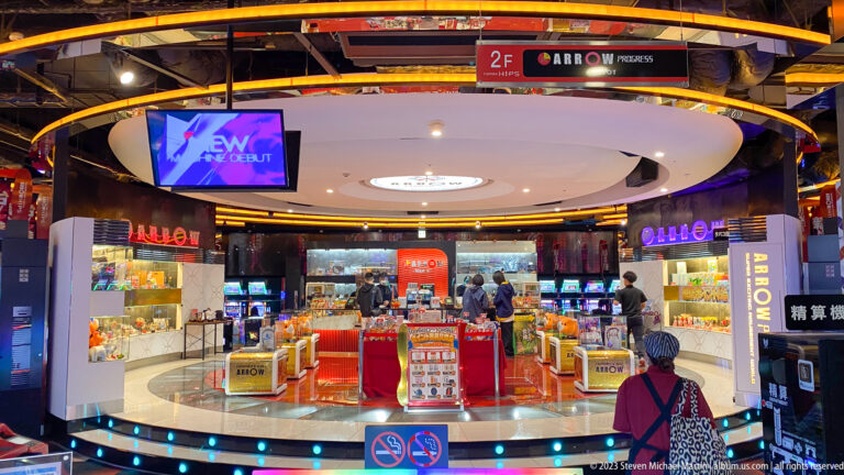 Bright circular Arrow kiosk with display cases and small goods inside an Osaka complex.