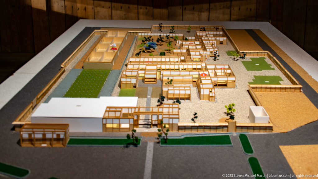 Detailed scale model of Takayama Jinya with low timber buildings, courtyards, gates, gardens, and surrounding walls.