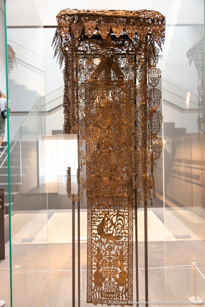 Tall gilt-bronze Kanjō-ban ritual banner with openwork canopy and suspended ornaments.