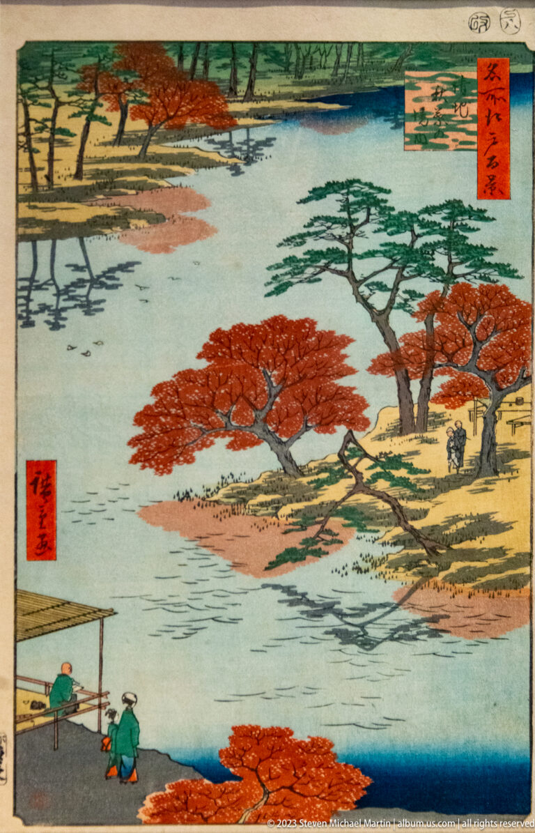 Japanese woodblock landscape with lake, red autumn trees, pines, hills, and small figures.
