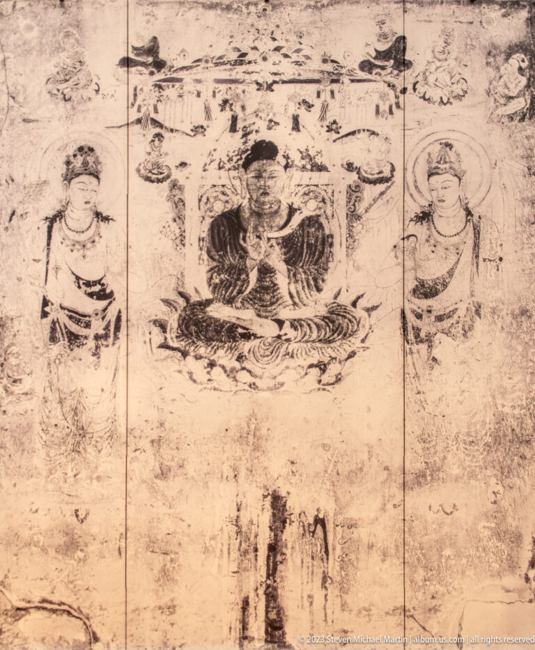 Faded Buddhist mural with a seated central Buddha and two standing haloed attendants.