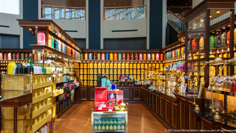 Dark wood shop lined with colorful tins, bottles, and boxed specialty goods.