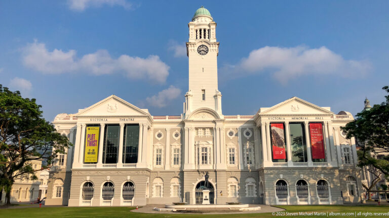 Centered symmetrical façade of Victoria Theatre and Concert Hall beneath a blue sky.