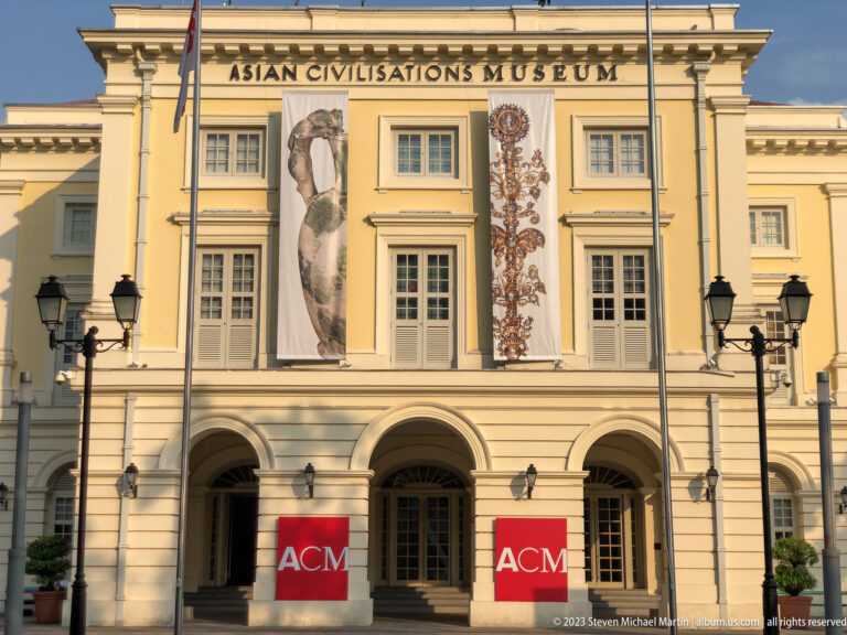 Asian Civilisations Museum façade with arched entrances, exhibition banners, and red ACM signs.