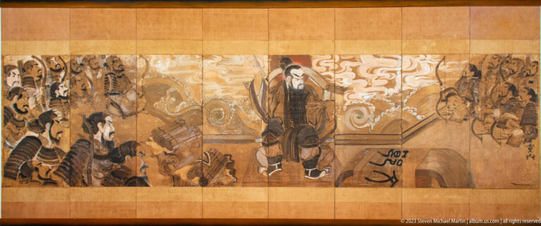 Wide brown-and-gold mural with robed figures, horses, birds, and swirling cloud forms.