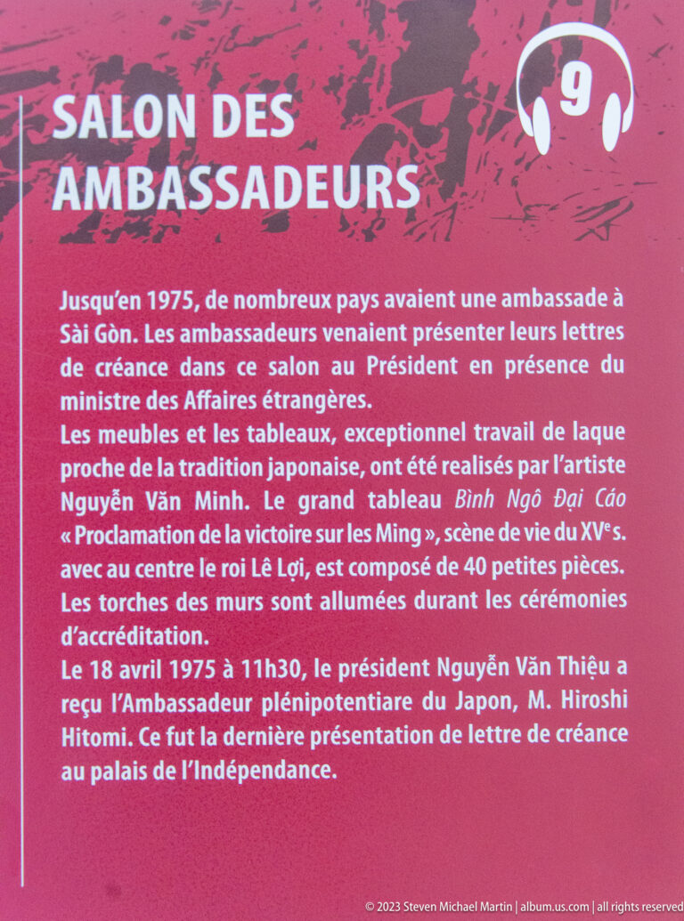 Red French-language panel titled Salle des Ambassadeurs with white historical text.