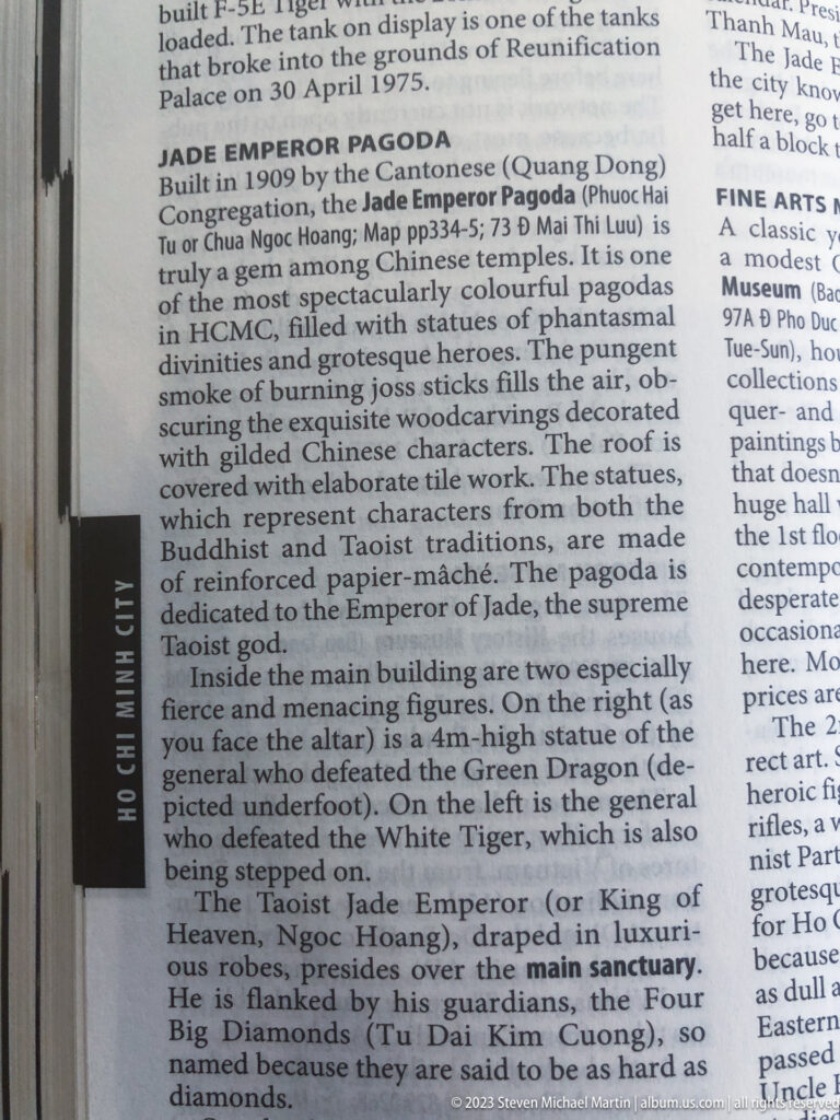 Close view of an English guidebook page describing the Jade Emperor Pagoda and its principal deities.