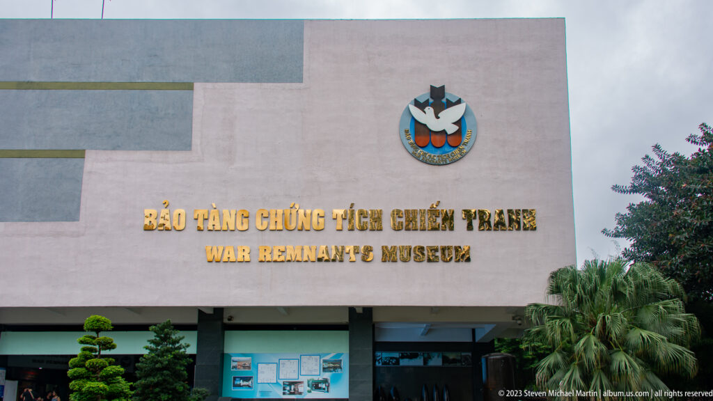Front façade of the War Remnants Museum with bilingual gold lettering.