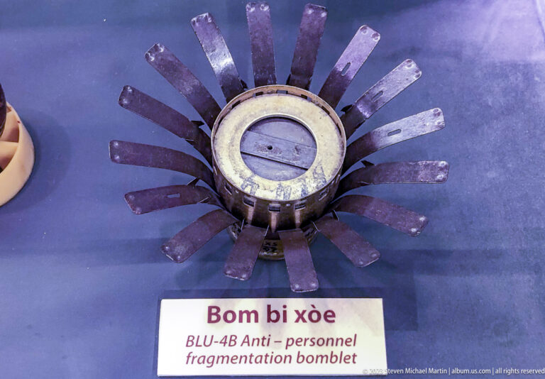 BLU-48 bomblet with radial metal fins spread around its body.