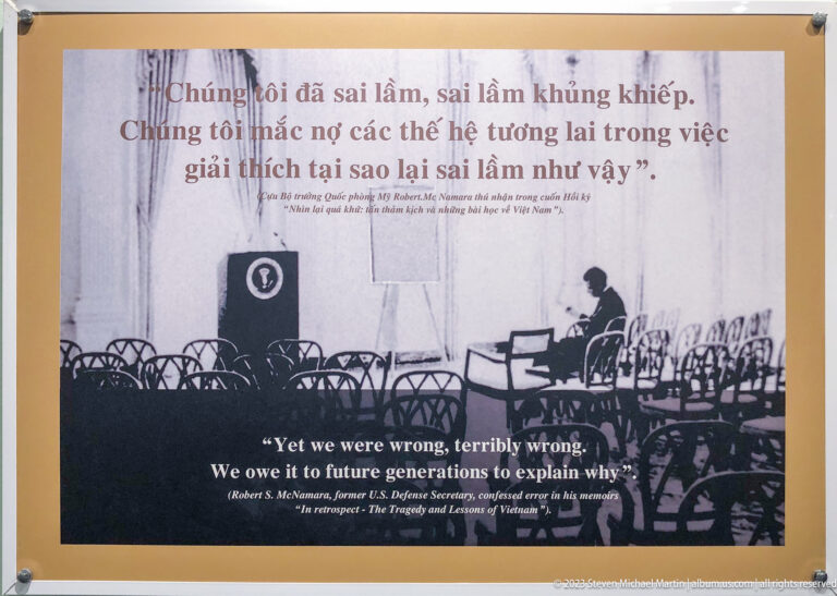 Robert McNamara quotation panel with an empty conference-room photograph.