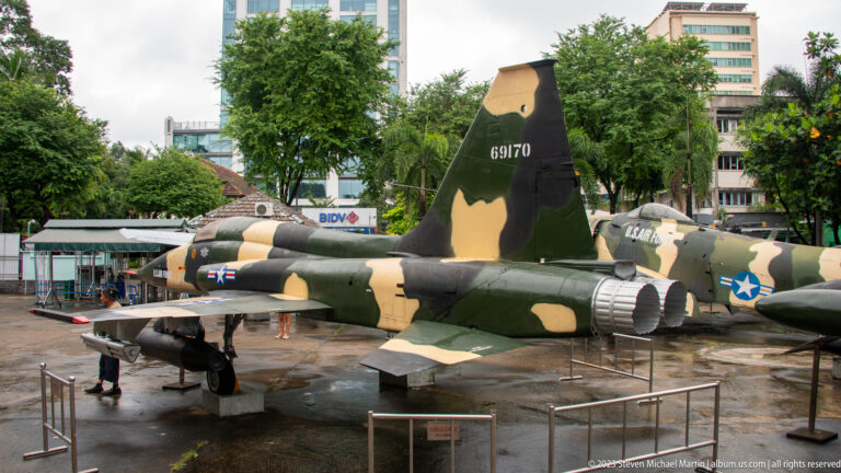 Camouflaged Northrop F-5 fighter aircraft displayed outdoors.