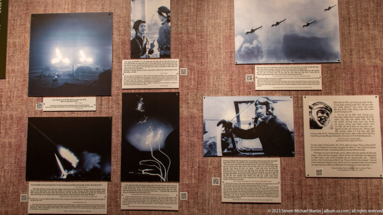 Brown exhibition panel with aircraft, bombing, and pilot photographs.