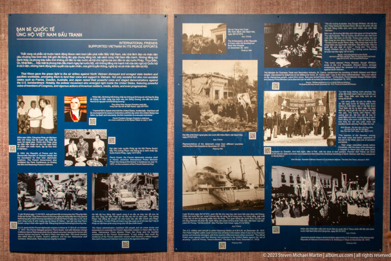Pair of blue museum panels filled with archival photographs and bilingual text.
