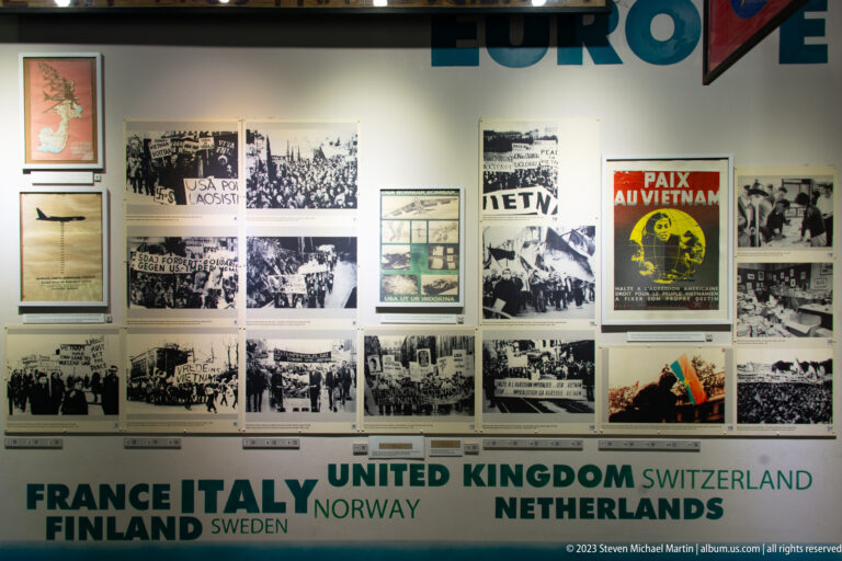 European antiwar display with photographs, posters, and country names.