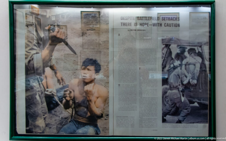 Framed newspaper spread with wartime photographs and the headline “There Is Hope—With Caution.”