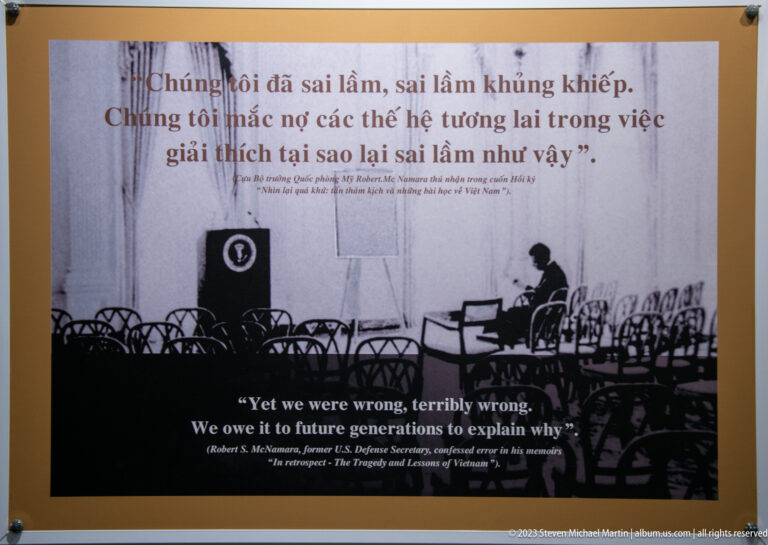 Robert McNamara quotation panel with an empty conference-room photograph.