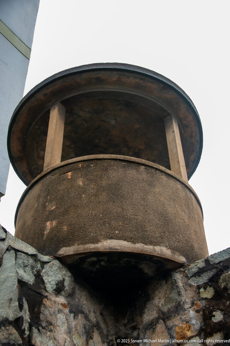Low-angle view of a circular guard platform above a stone wall.