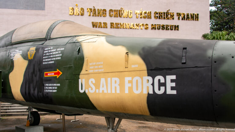 Close view of U.S. Air Force lettering and rescue markings on a camouflaged aircraft.