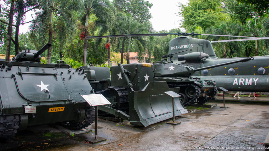 Armored vehicles and a U.S. Army helicopter grouped in the museum courtyard.