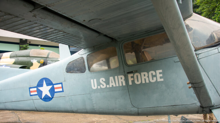 Close side view of an O-1 Bird Dog cockpit with U.S. Air Force markings.