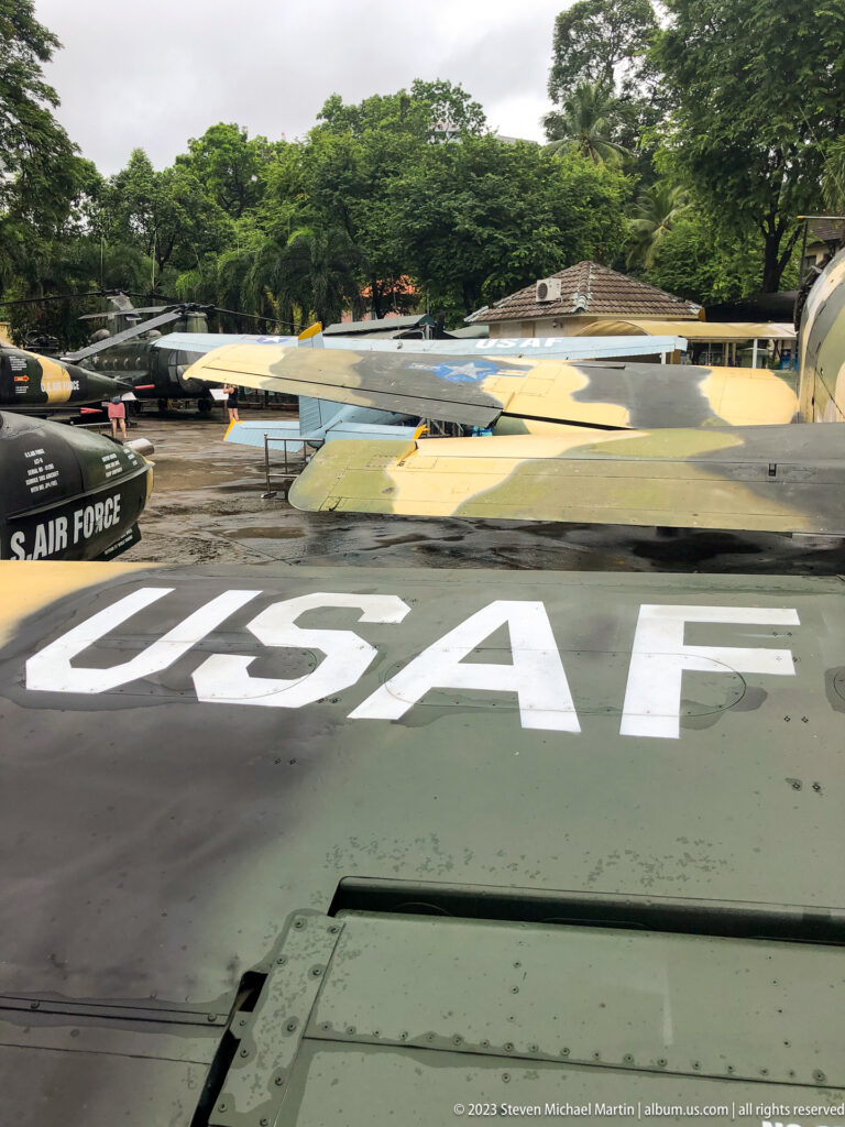 Large white USAF letters on an aircraft wing with other planes beyond.