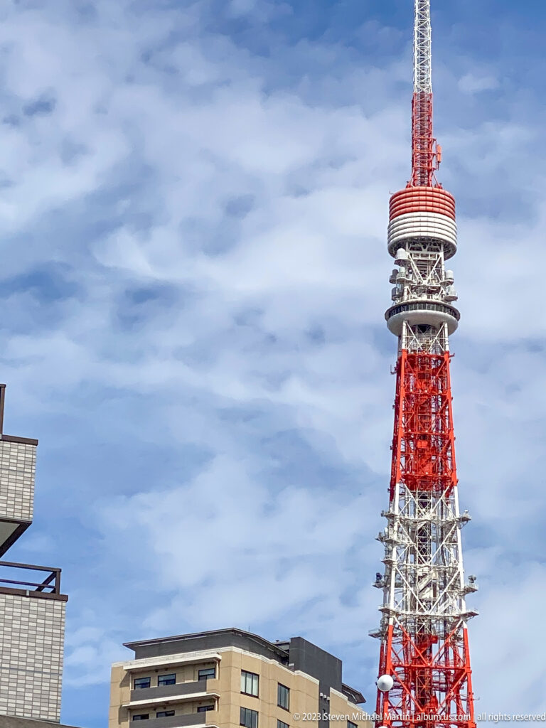 Daylight close view of Tokyo Tower’s red-and-white upper structure and observation deck.
