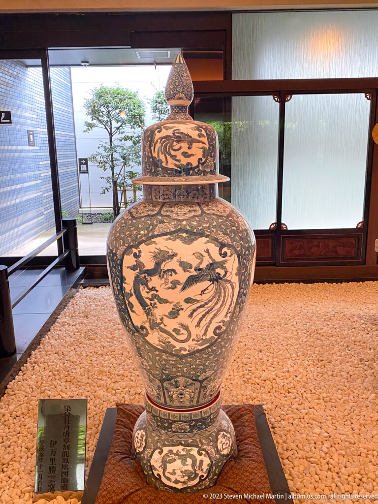 Large lidded polychrome jar decorated with dragons, phoenixes, clouds, and floral borders.