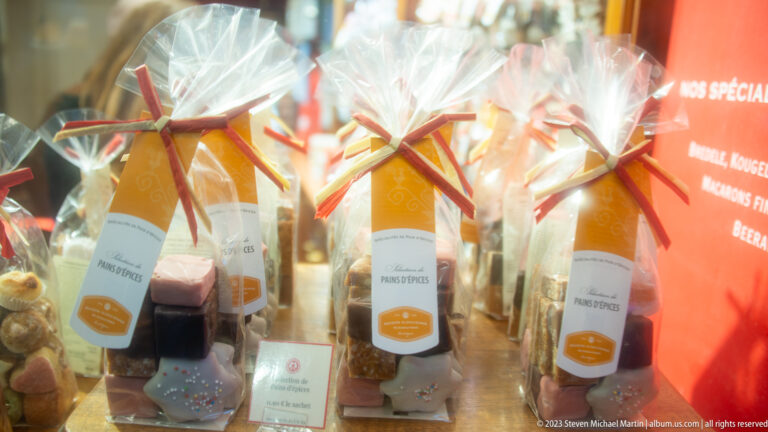 Rows of cellophane gift bags tied with ribbons and filled with sweets and pain d'épices products.