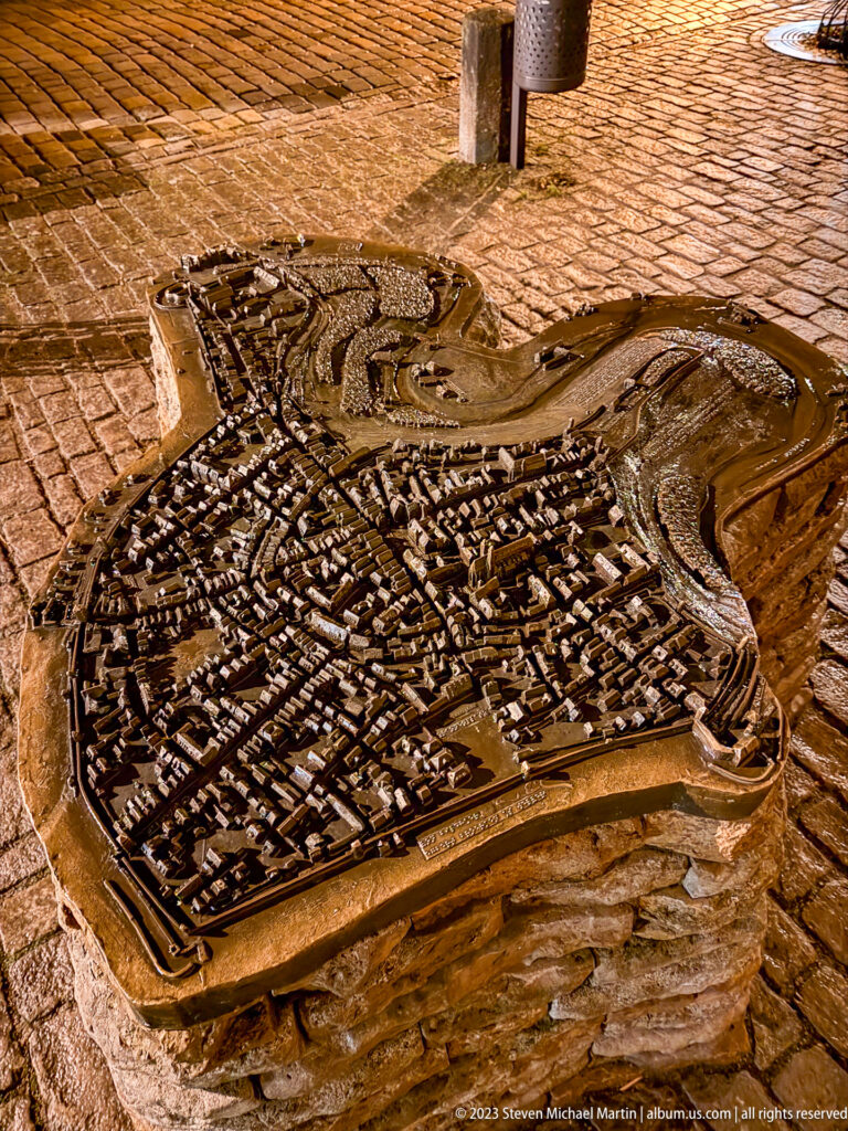Bronze raised-relief model of Rothenburg showing dense streets, buildings, towers, walls, and surrounding terrain.