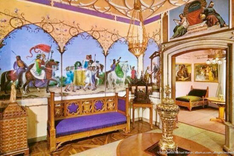 Purple-upholstered carved bench beneath equestrian murals, with ornate metalwork and an adjoining room beyond.