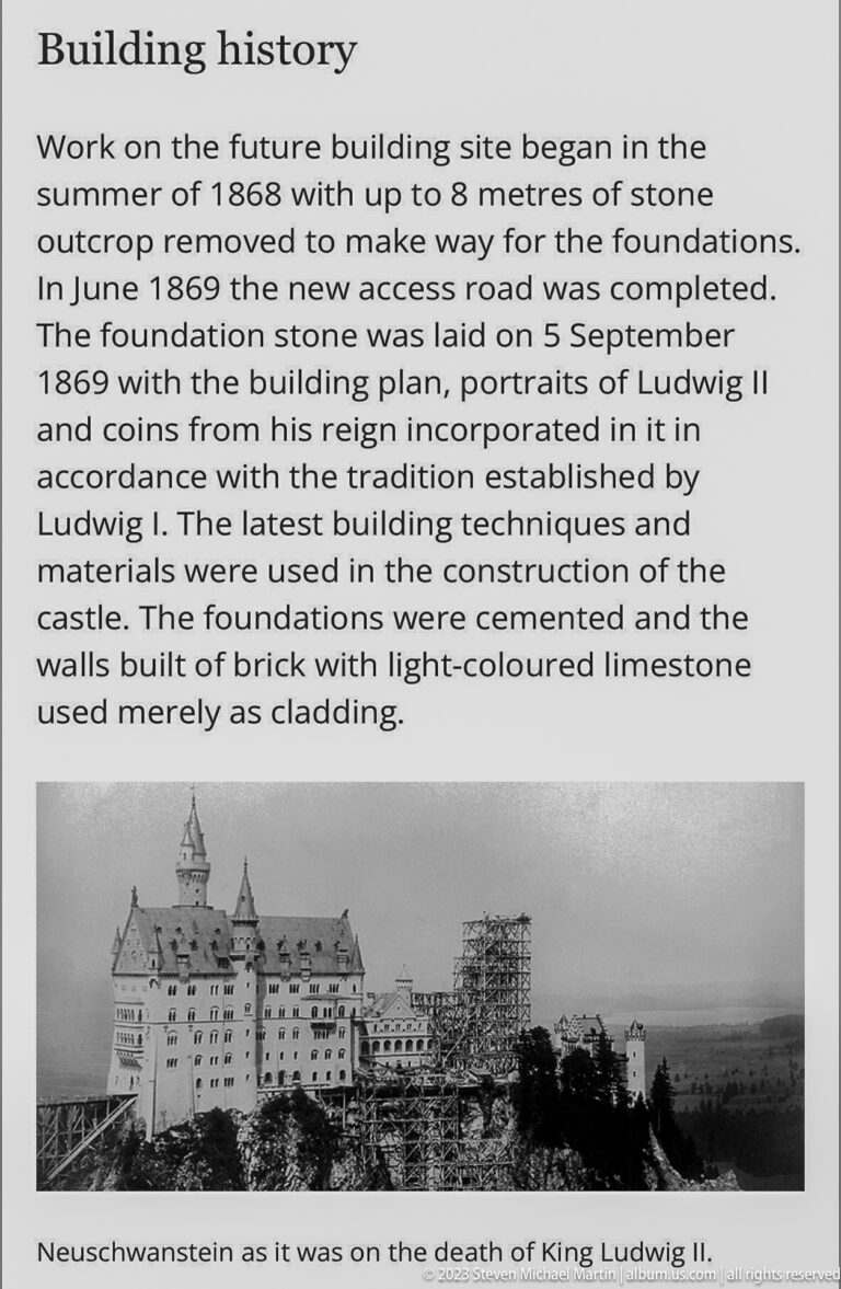 Building-history panel with construction text and a black-and-white photograph of unfinished Neuschwanstein Castle.