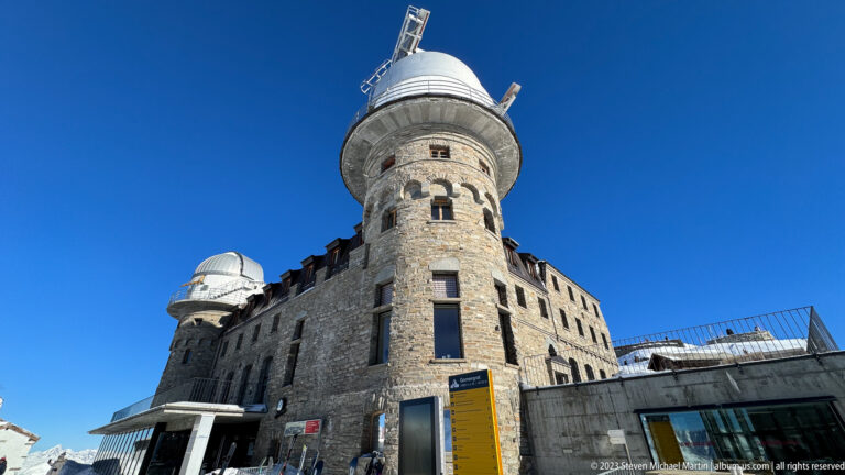 Stone 3100 Kulmhotel Gornergrat with two round towers topped by white observatory domes.