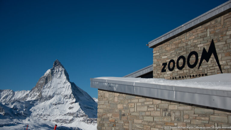 Stone building marked ZOOOM THE MATTERHORN beside a clear view of the Matterhorn.