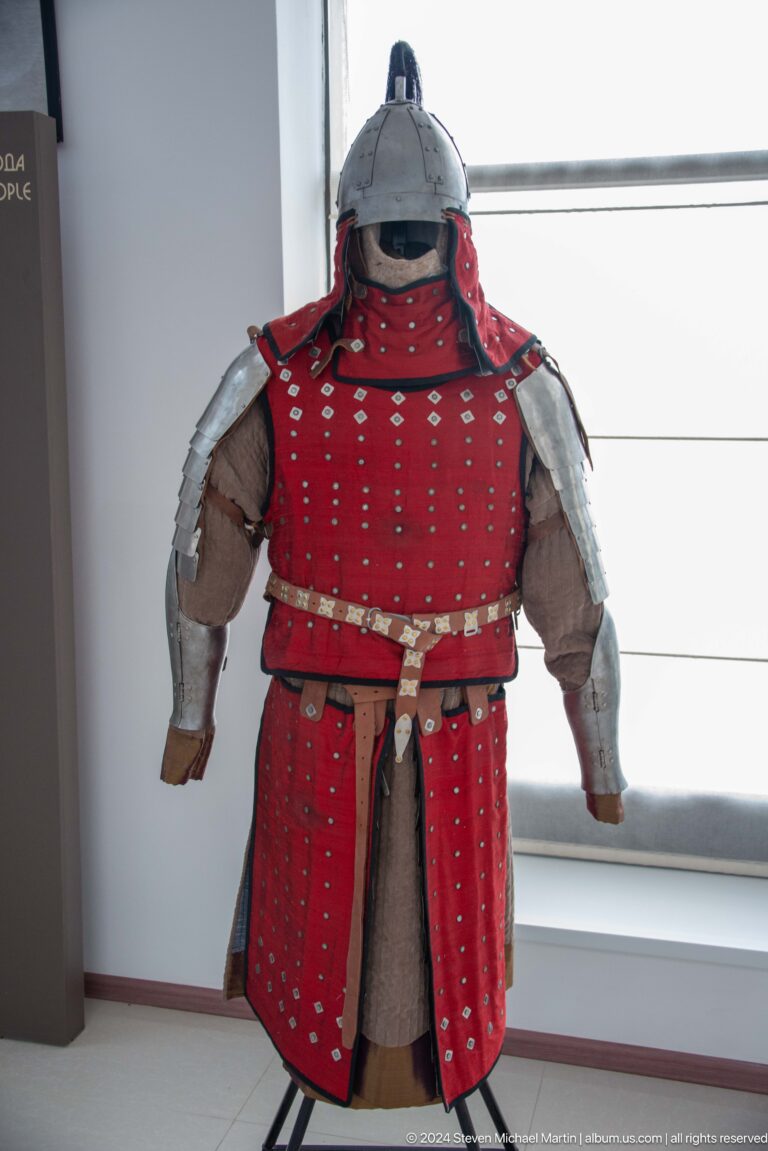 Red lamellar armor mounted on a mannequin.