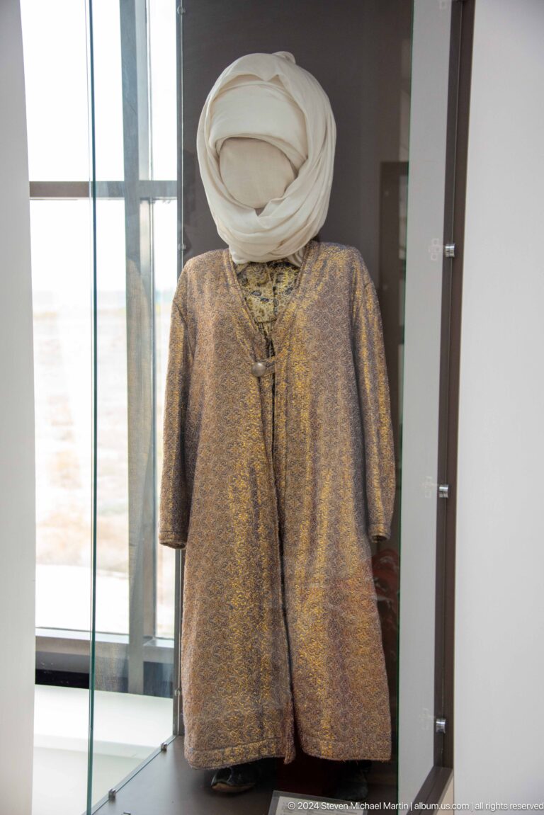 Long patterned robe displayed on a mannequin.