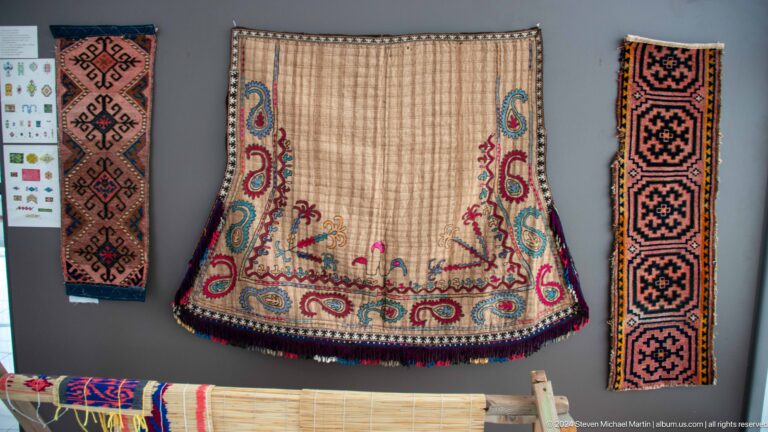 Embroidered textile bag with colorful border.
