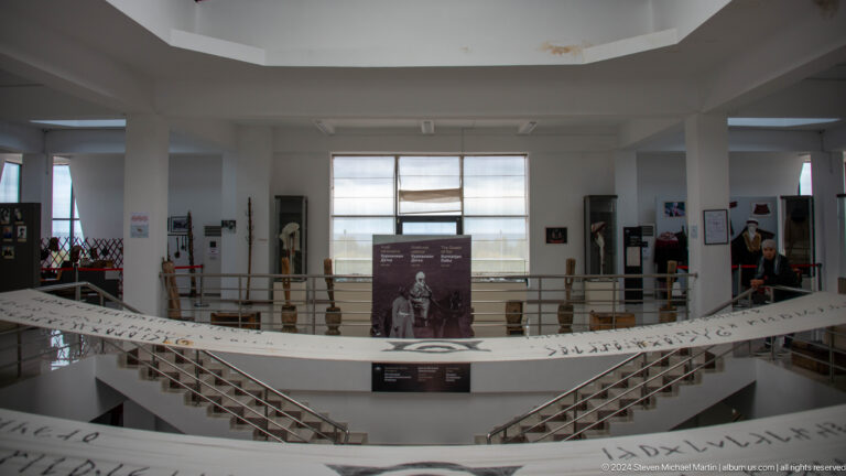 Wide museum interior with display cases.