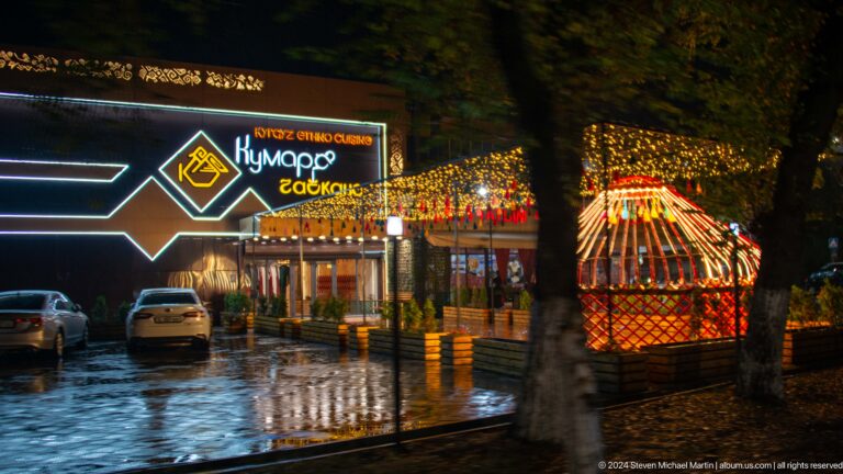 Illuminated roadside café at night.