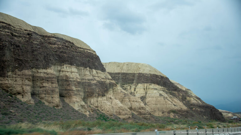 Striped pale and dark eroded hillside.