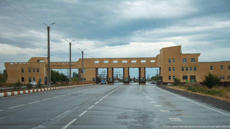 Road approaching a broad checkpoint structure.