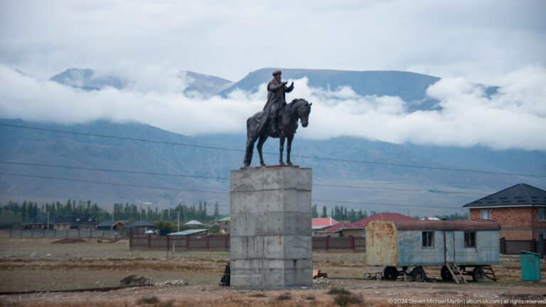 Equestrian statue on a tall stone pedestal.