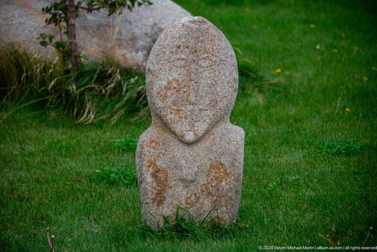 Small rounded stone figure on grass.
