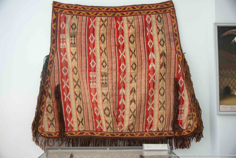 Striped woven bag with geometric patterns.
