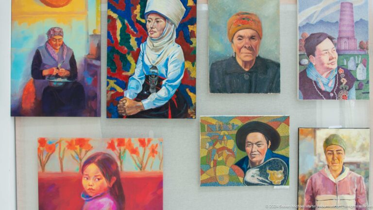 Group of painted portraits of local people.
