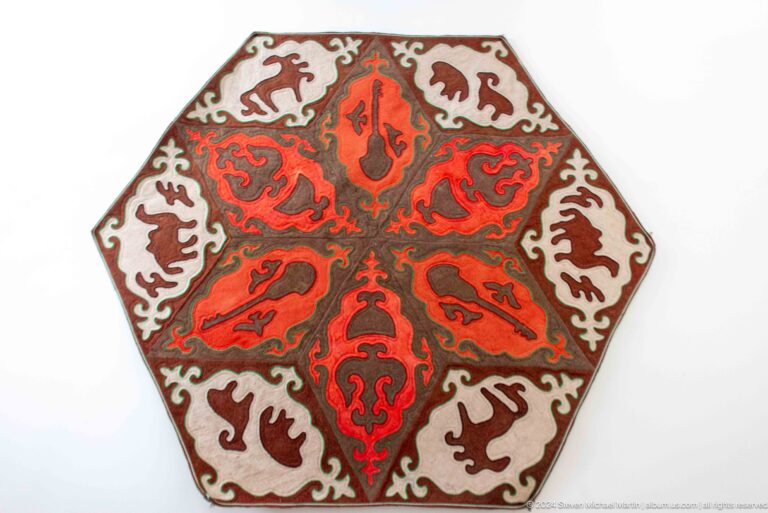 Red hexagonal felt carpet with white ornament.