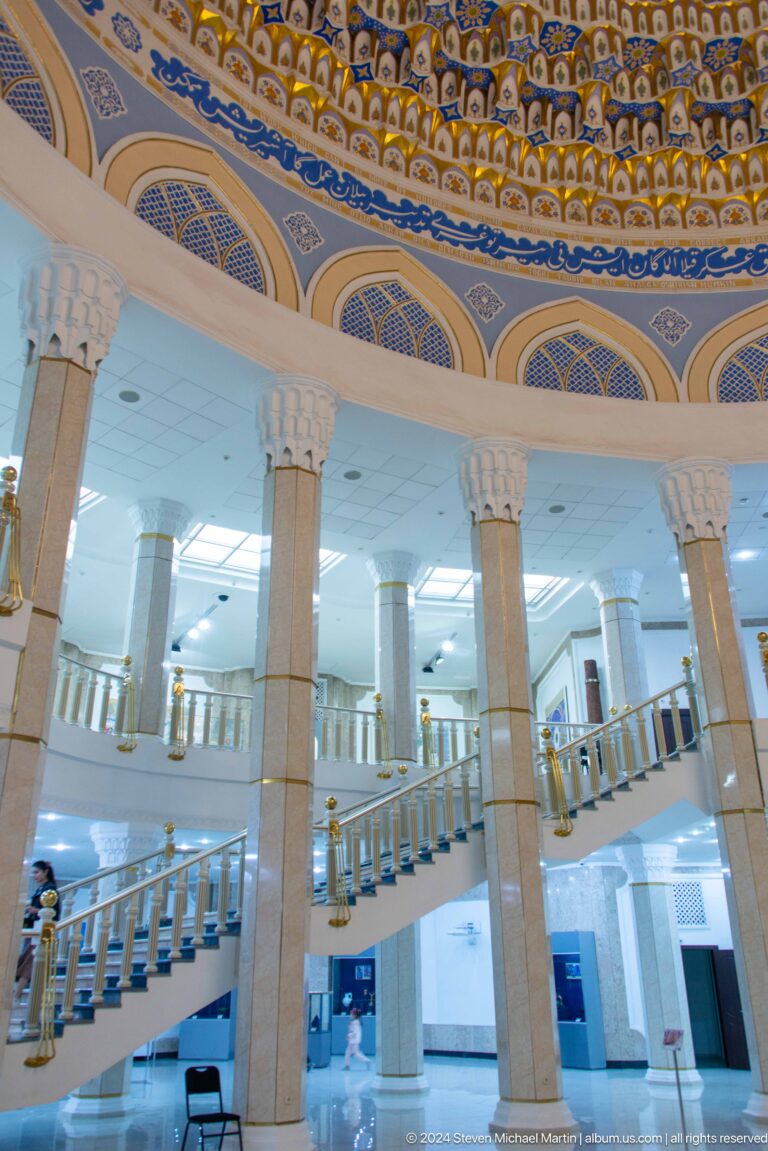 Tall pale columns rising through a bright open atrium.