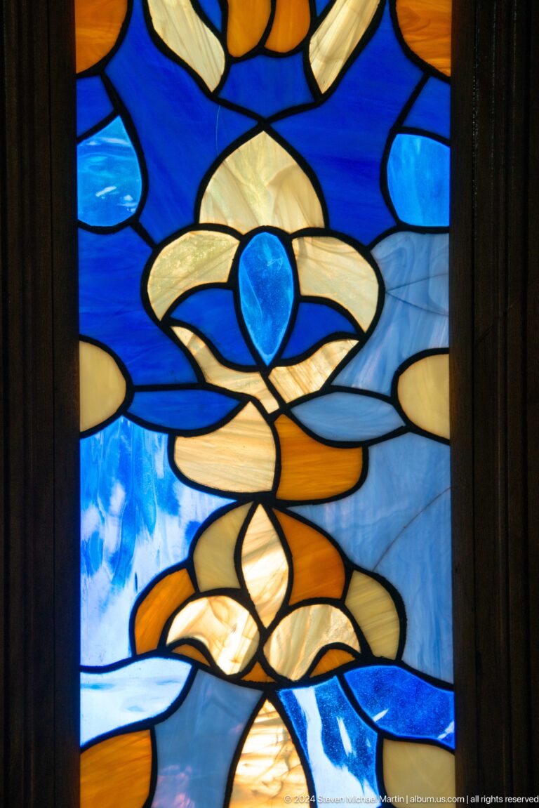 Large blue flower-like motif filling the glass panel.