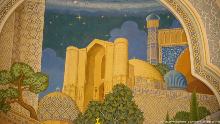 Golden portal, domes, and tower beneath a starry sky.
