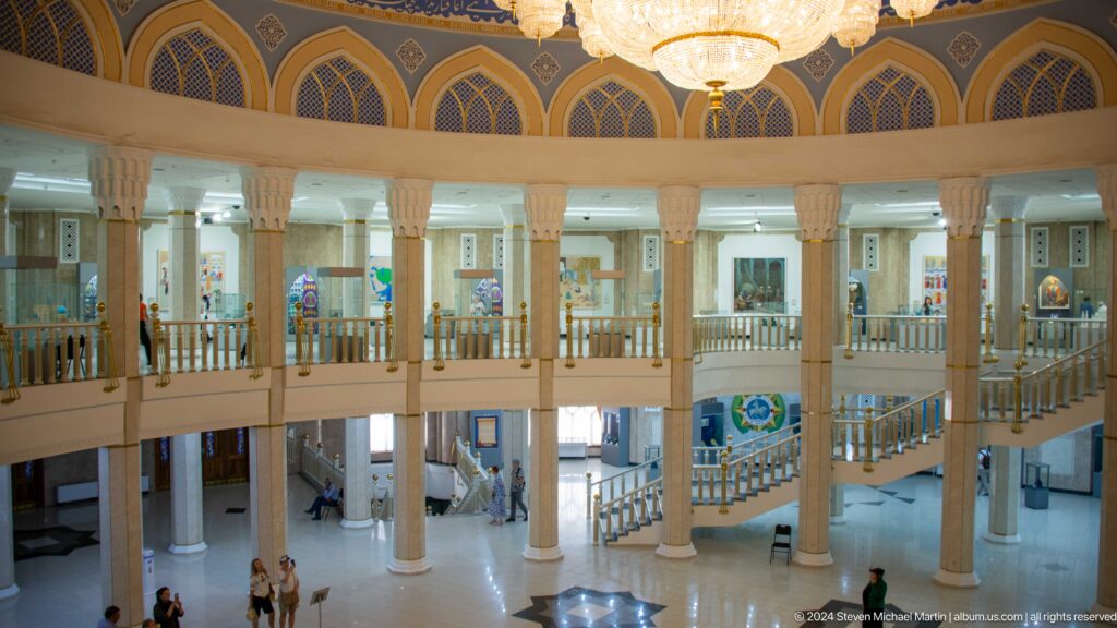 Wide view across columns, railings, stairs, and open floor.